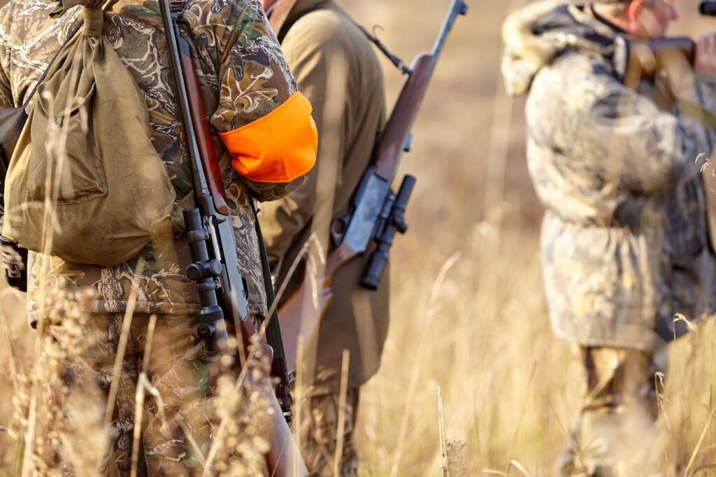 A group of hunters in a wooded area reflecting huntings popularity in American culture