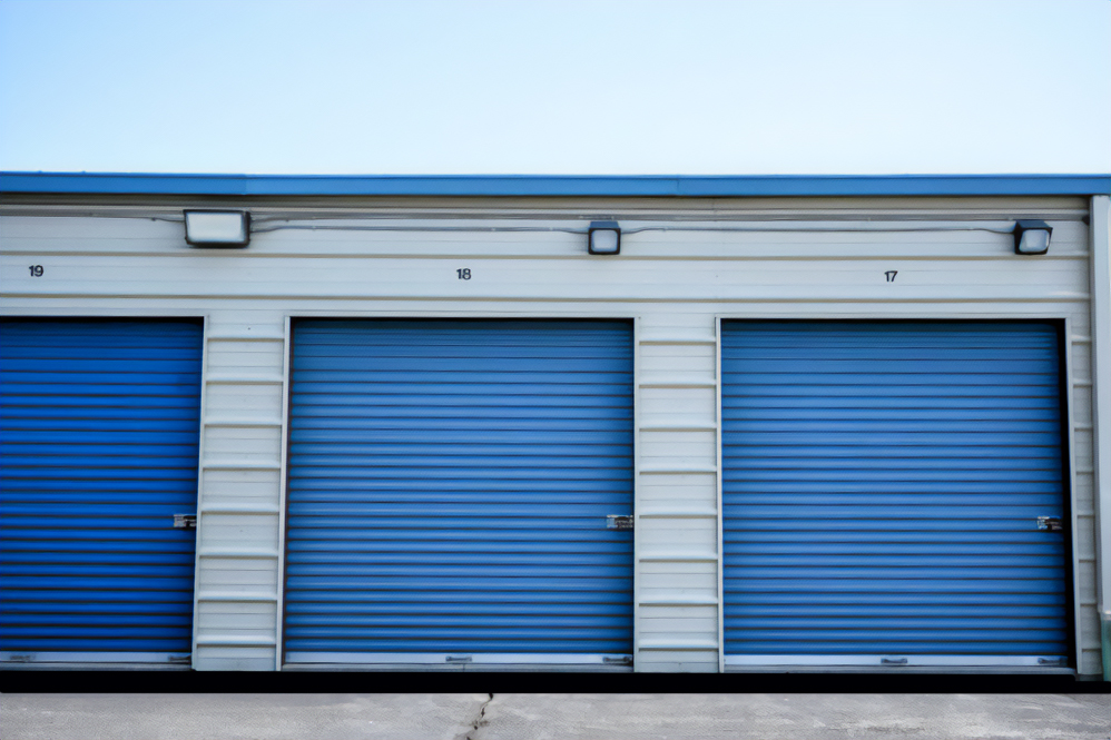 Blue self-storage units labeled 'Keypers Storage' situated in a parking lot.