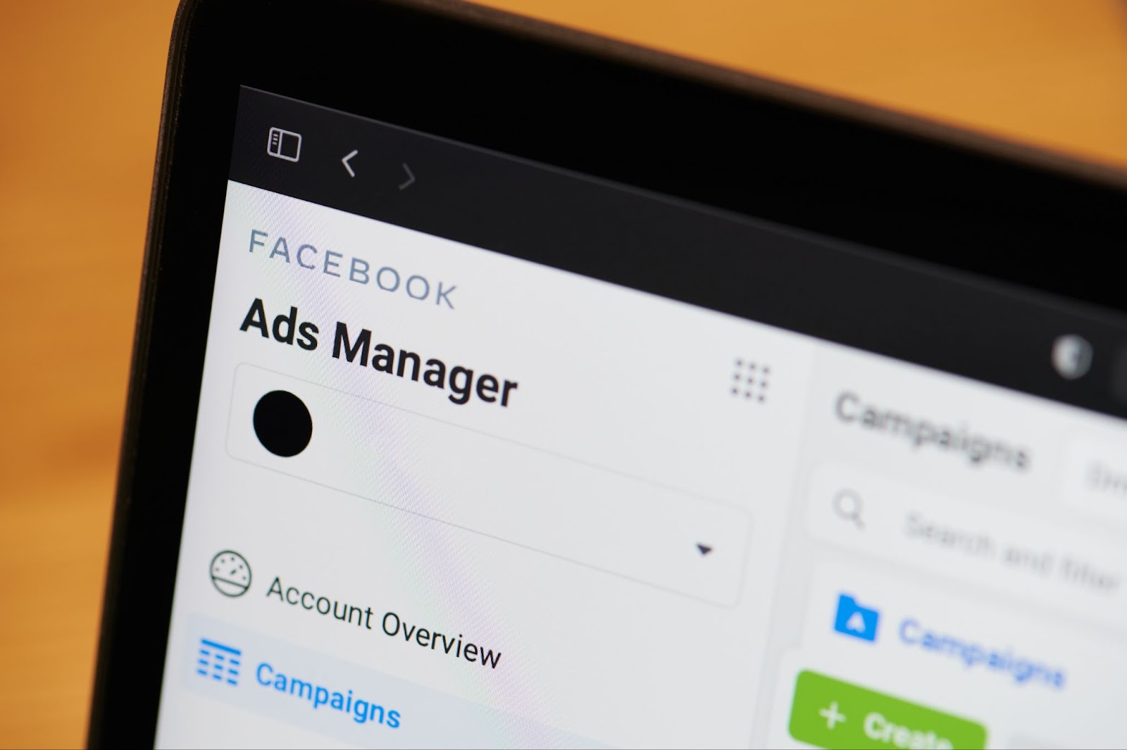 A tablet screen showing the Facebook Ads Manager interface with options like Account Overview and Campaigns, featuring a Create button.