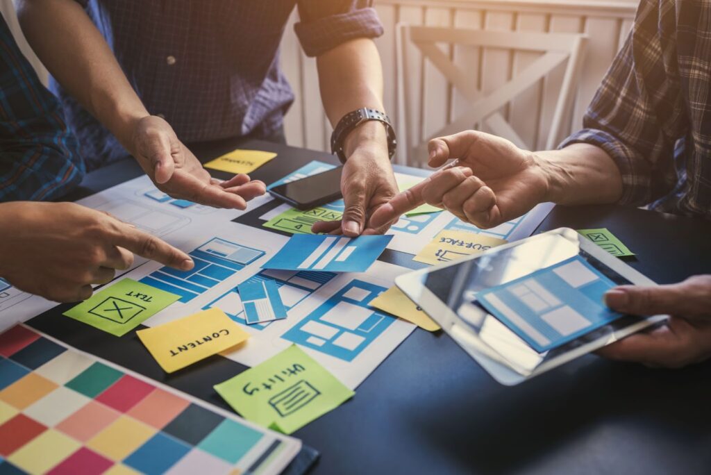 A team collaborating on a project with paper and sticky notes, focusing on content marketing and SEO