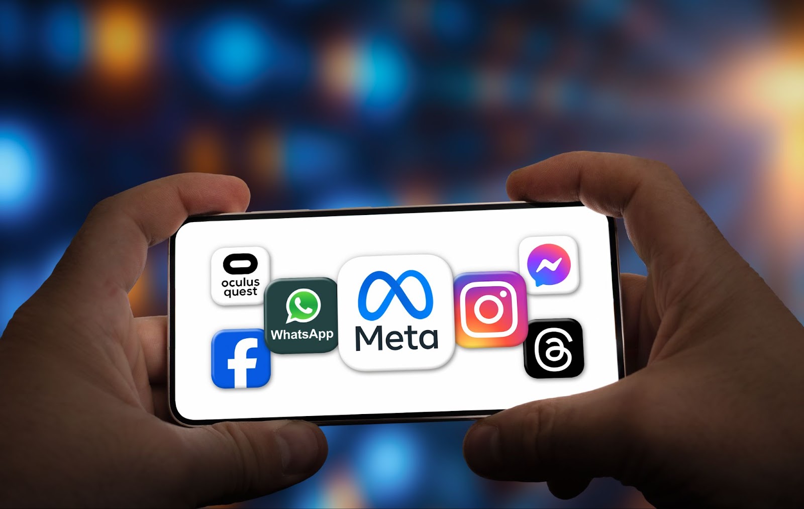 Hands holding a smartphone displaying Meta app icons (Oculus Quest, WhatsApp, Facebook, Meta, Instagram, Messenger) against a blurred, colorful background.